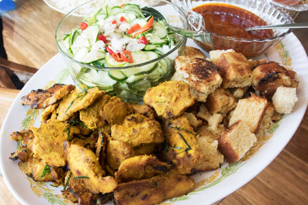 chicken satay with dipping sauce with cucumberの写真素材
