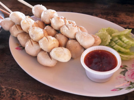 skewer pork ball on bamboo stick with sauceの写真素材