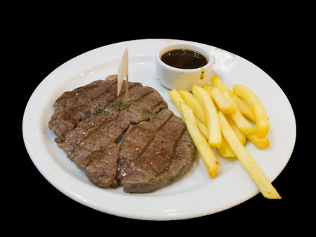 steak, fried and sauce in a white dishの写真素材