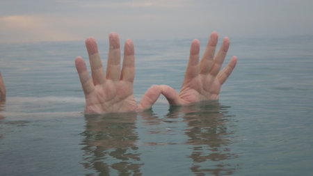 human hands up in waterの写真素材