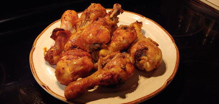 Grilled chicken legs on a plate, close-up shot.の写真素材