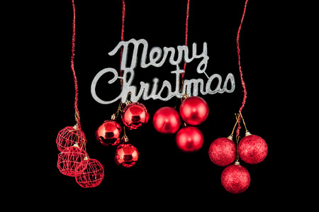 Christmas background character silver with a red ornament on black backgroundの写真素材