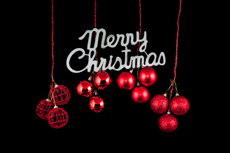 Christmas background character silver with a red ornament on black backgroundの写真素材