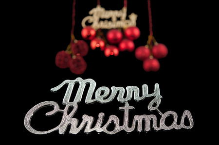 Christmas background character silver with a red ornament on black backgroundの写真素材