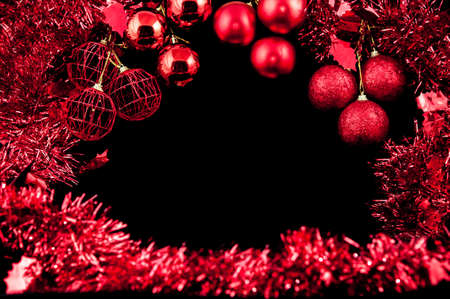 Christmas background with a red ornament on black backgroundの写真素材