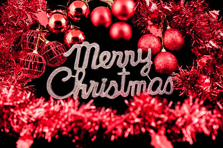 Christmas background character silver with a red ornament on black backgroundの写真素材