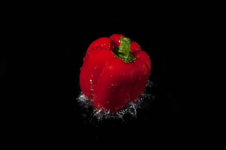 Colorful bell pepper vegetable on black background