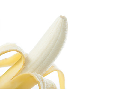 Peeled banana on white backgroundの写真素材