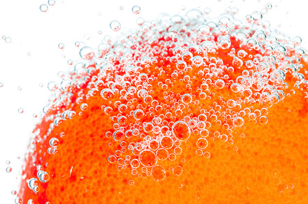 fresh orange with bubbles in the waterの写真素材
