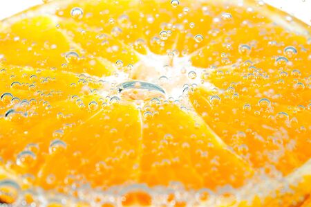 fresh orange with bubbles in the waterの写真素材