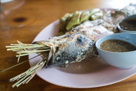 snakehead fish with salt coated with spices sauceの写真素材