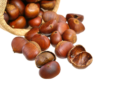 Many chestnuts in small sack isolated on white backgroundの写真素材