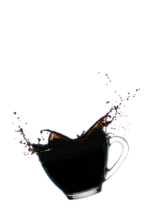Coffee splash in Clear glass bowl isolated on white backgroundの写真素材