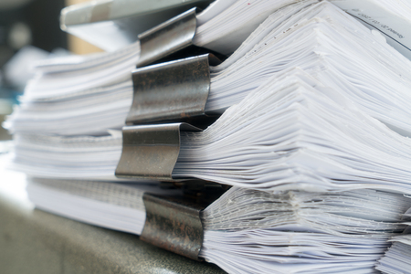 Stack of white papers sheet on office background.
