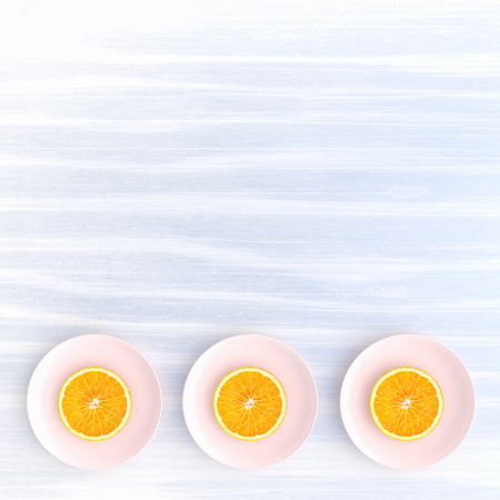 Orange slices on plate pink color on blue background and copy space, top view. concept pastel color,3D render.の写真素材