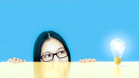 Young Women looked at the light bulb. Showing the idea concept, 3D Render.の写真素材