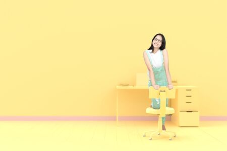 Young Woman students on the office chair with a desk yellow wall background, pastel color idea concept.の写真素材