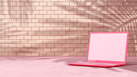 Pink laptop with decoration minimal. Shadow from tree and window on brick wall. Mock-up computer and minimalism concept, 3D Render.の写真素材