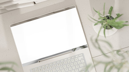 Laptop Mock-Up Empty screen on cement floor front white brick wall High angle shot. shadow of tree and window. Decorate minimalist style, 3D Render.の写真素材