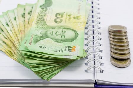 THB Cash , coin with money thailand on notebook