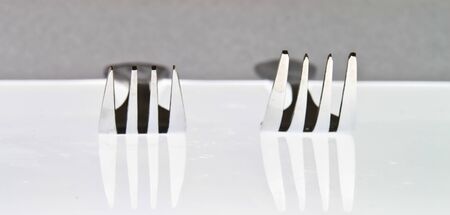 Two silver fork on white backgroundの写真素材