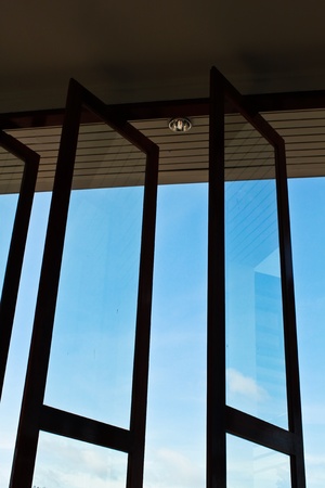 Opened glass window new in room with view to blue sky.の写真素材
