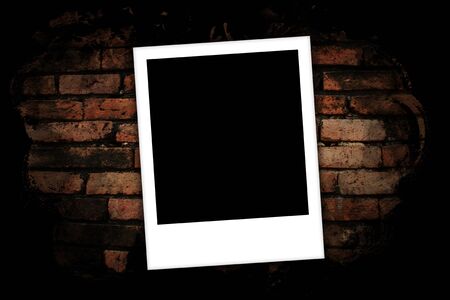 Photo frames on brick wall background の写真素材