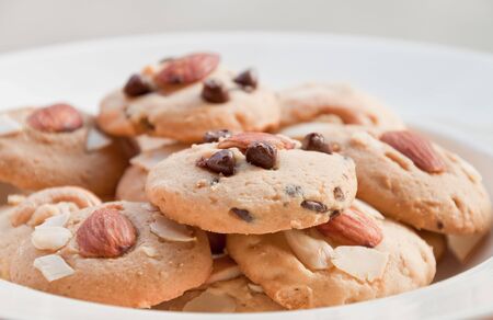 chocolate chip cookie and almond cookie on the white dish の写真素材