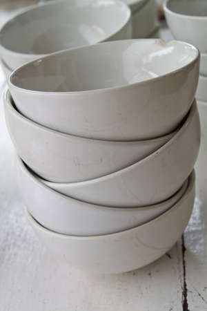 Stack of white bowls on the table wood 