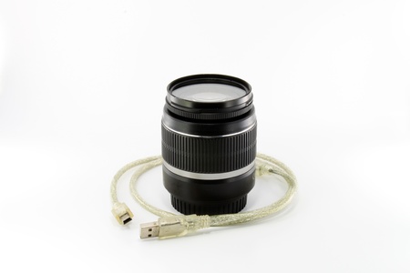Black camera lens and USB cable isolated on white backgroundの写真素材