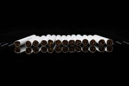 Cigarettes in a row and reflection  World No Tobacco Day の写真素材