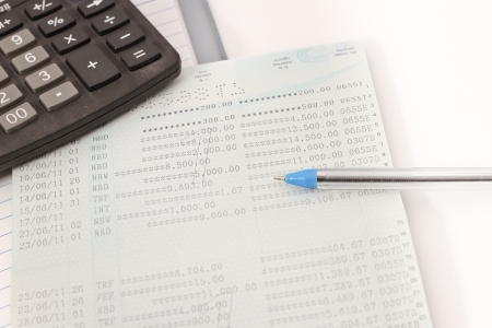 Papers on financial figures with calculator and pen の写真素材