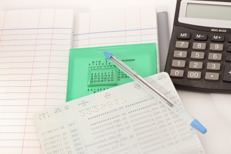 Papers on financial figures with calculator and pen の写真素材