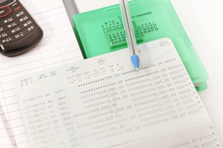 Papers on financial figures with telephone and pen の写真素材