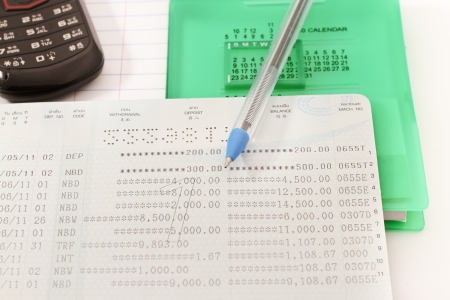 Papers on financial figures with telephone and pen の写真素材