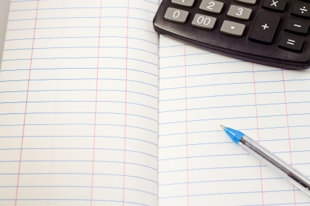 Papers on financial figures with calculator and pen の写真素材