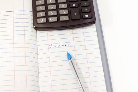 Papers on financial figures with calculator and pen の写真素材
