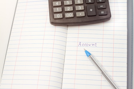 Papers on financial figures with calculator and pen の写真素材