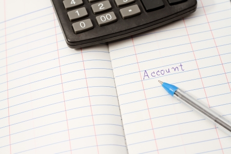 Papers on financial figures with calculator and pen の写真素材