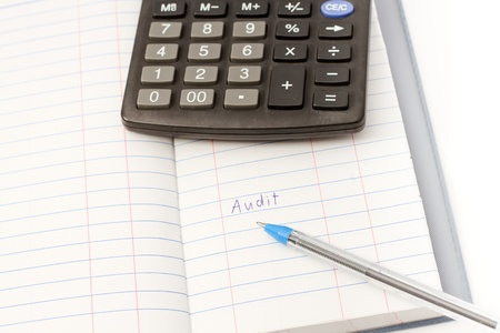 Papers on financial figures with calculator and pen の写真素材
