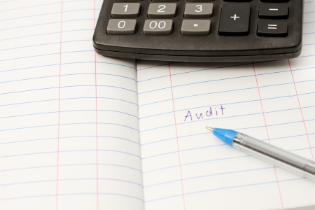 Papers on financial figures with calculator and pen の写真素材