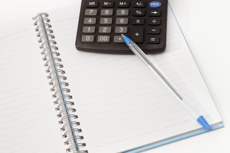 Papers on financial figures with calculator and pen の写真素材