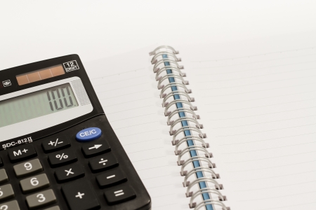 Calculator, press the number to 100 and blank book の写真素材