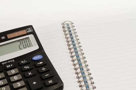 Calculator, press the number to 200 and blank book の写真素材
