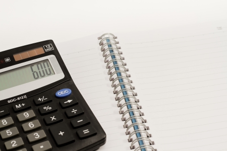Calculator, press the number to 600 and blank book の写真素材