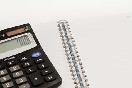 Calculator, press the number to 700 and blank book の写真素材
