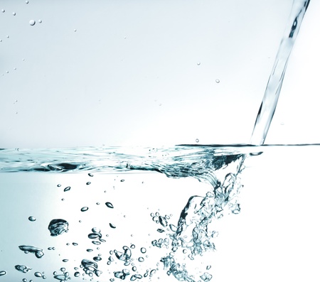 Flowing water with air bubbles. Abstract water splash.の写真素材