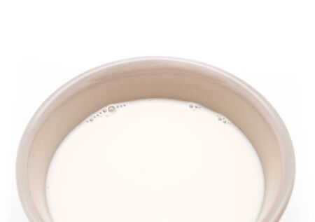 Ceramic cup of milk on white background の写真素材