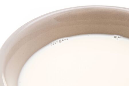 Ceramic cup of milk on white background の写真素材