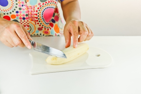 Chef cutting Banana on a board  Banana slices の写真素材
